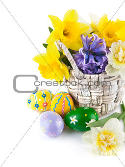 Easter eggs with spring flowers in basket