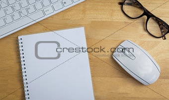 Overhead of notebook and glasses
