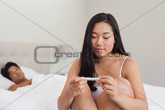 Woman reading pregnancy test
