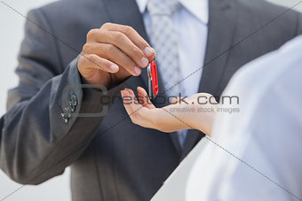 Estate agent giving the key to buyer