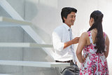 Man talking with his girlfriend wearing a floral dress
