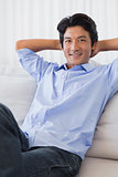 Happy man relaxing on couch