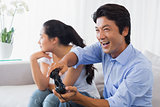Woman being ignored by boyfriend playing video games