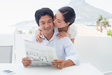 Couple reading a newspaper together