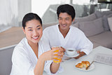 Couple in bathrobes spending the morning together