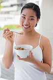 Happy woman having a bowl of cereal