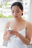 Asian woman texting on phone