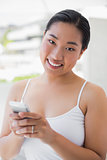 Asian woman texting on phone