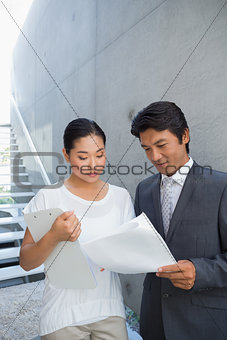 Estate agent showing lease to customer and smiling