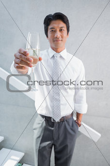 Happy man holding flute of champagne