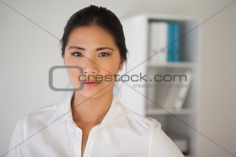 Casual businesswoman frowning at camera