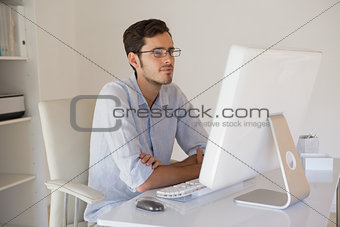 Casual businessman sitting at his desk