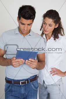 Casual business team looking at tablet together