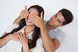 Man covering his pretty girlfriends eyes