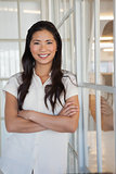 Casual businesswoman smiling at camera with arms crossed