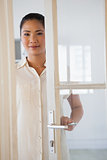 Casual businesswoman opening glass door