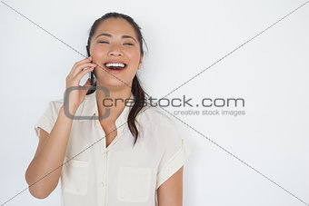 Casual businesswoman laughing on the phone