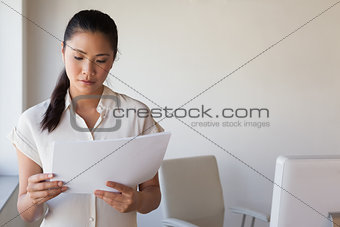 Casual businesswoman reading document