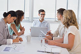 Casual businessman talking to team during meeting