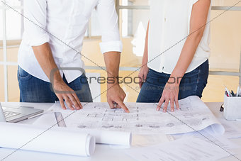 Casual architecture team working together at desk
