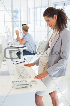 Pregnant casual businesswoman using computer