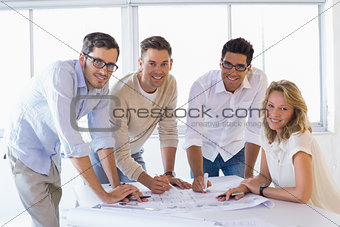Casual architecture team working together smiling at camera