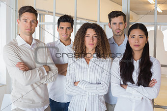 Casual business team looking at camera with arms crossed