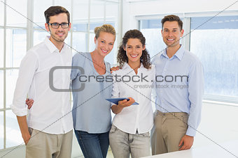 Casual business team smiling at camera