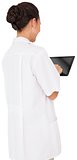 Pretty brown haired nurse using tablet pc
