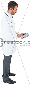Handsome young doctor using tablet pc