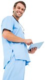 Handsome surgeon in blue scrubs using tablet pc