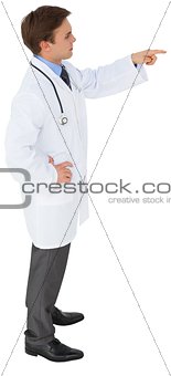 Young doctor in lab coat pointing