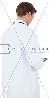 Young doctor in lab coat using tablet pc