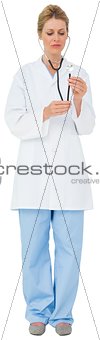 Blonde doctor listening with stethoscope