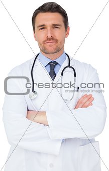 Handsome young doctor with arms crossed