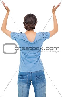 Brunette woman in jeans gesturing