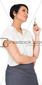 Thoughtful brown haired businesswoman in skirt