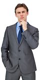 Thinking young businessman in grey suit