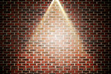 Red brick wall under spotlight