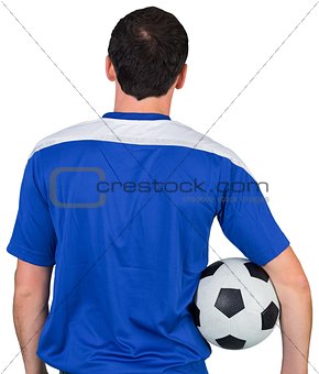 Football fan in blue holding ball