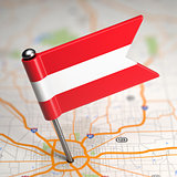 Austria Small Flag on a Map Background.