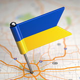 Ukraine Small Flag on a Map Background.