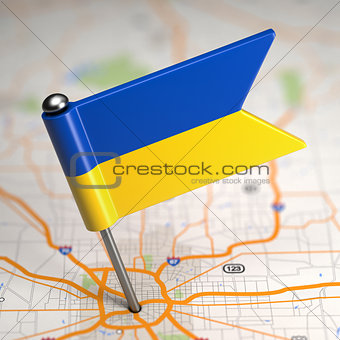 Ukraine Small Flag on a Map Background.