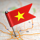 Vietnam Small Flag on a Map Background.