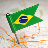 Brazil Small Flag on a Map Background.