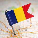 Romania Small Flag on a Map Background.
