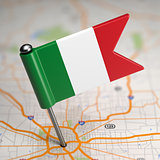 Italy Small Flag on a Map Background.