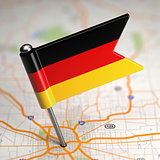 Germany Small Flag on a Map Background.