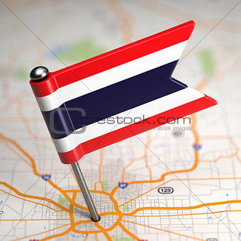 Thailand Small Flag on a Map Background.