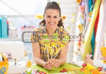 Smiling young woman showing hand made decorative eggs